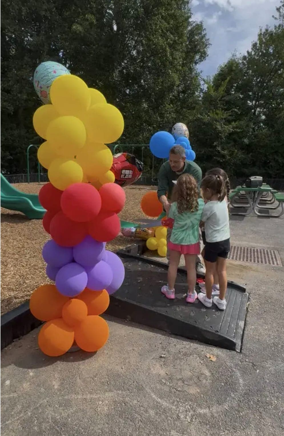 Young students take part in the playground ribbon cutting.